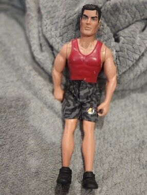 vintage 1997 Hasbro Action Man figure wearing a red tank top and camouflage